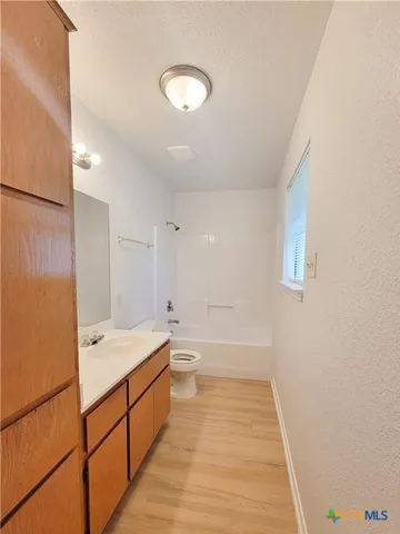 a spacious bathroom with a double vanity sink and a bathtub
