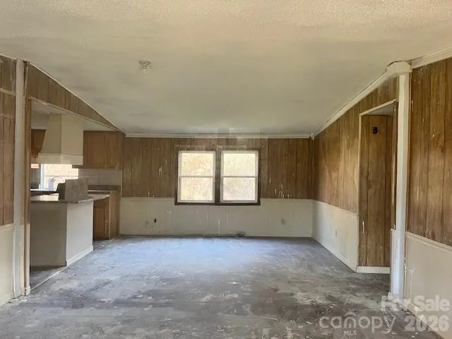 a room with a stove and a kitchen view