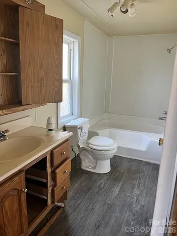 a bathroom with a sink a toilet and a bathtub