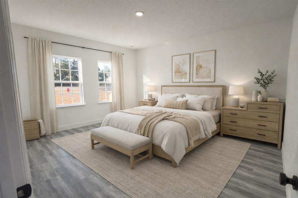 2703 Southwest 162nd Street Road Ocala, FL 34473 - Photo 11 of 39 a bedroom with a bed and wooden floor