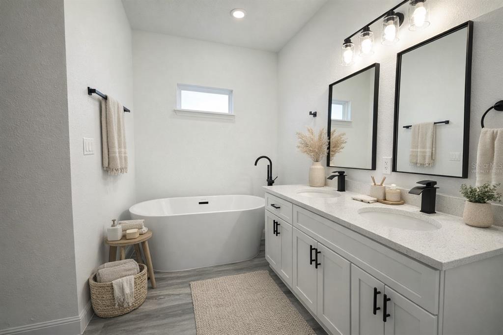 2703 Southwest 162nd Street Road Ocala, FL 34473 - Photo 14 of 39 a spacious bathroom with a double vanity sink mirror and bathtub