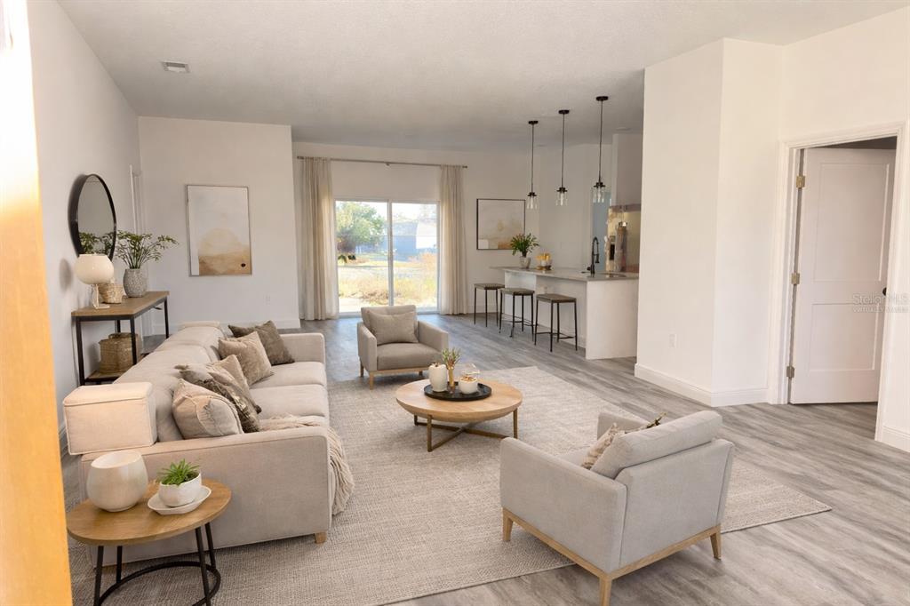 2703 Southwest 162nd Street Road Ocala, FL 34473 - Photo 2 of 39 a living room with furniture and a large window