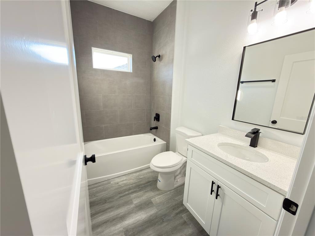 2703 Southwest 162nd Street Road Ocala, FL 34473 - Photo 28 of 39 a bathroom with a sink a toilet and shower