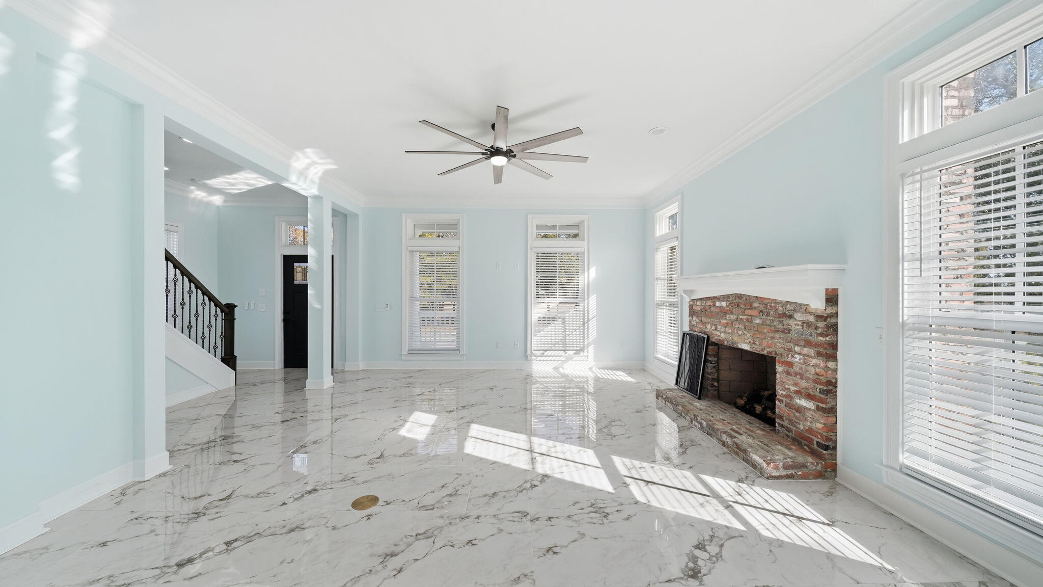 165 Staggerbush Street Freeport, FL 32439 - Photo 16 of 68 a view of a livingroom with a fireplace a chandelier and windows