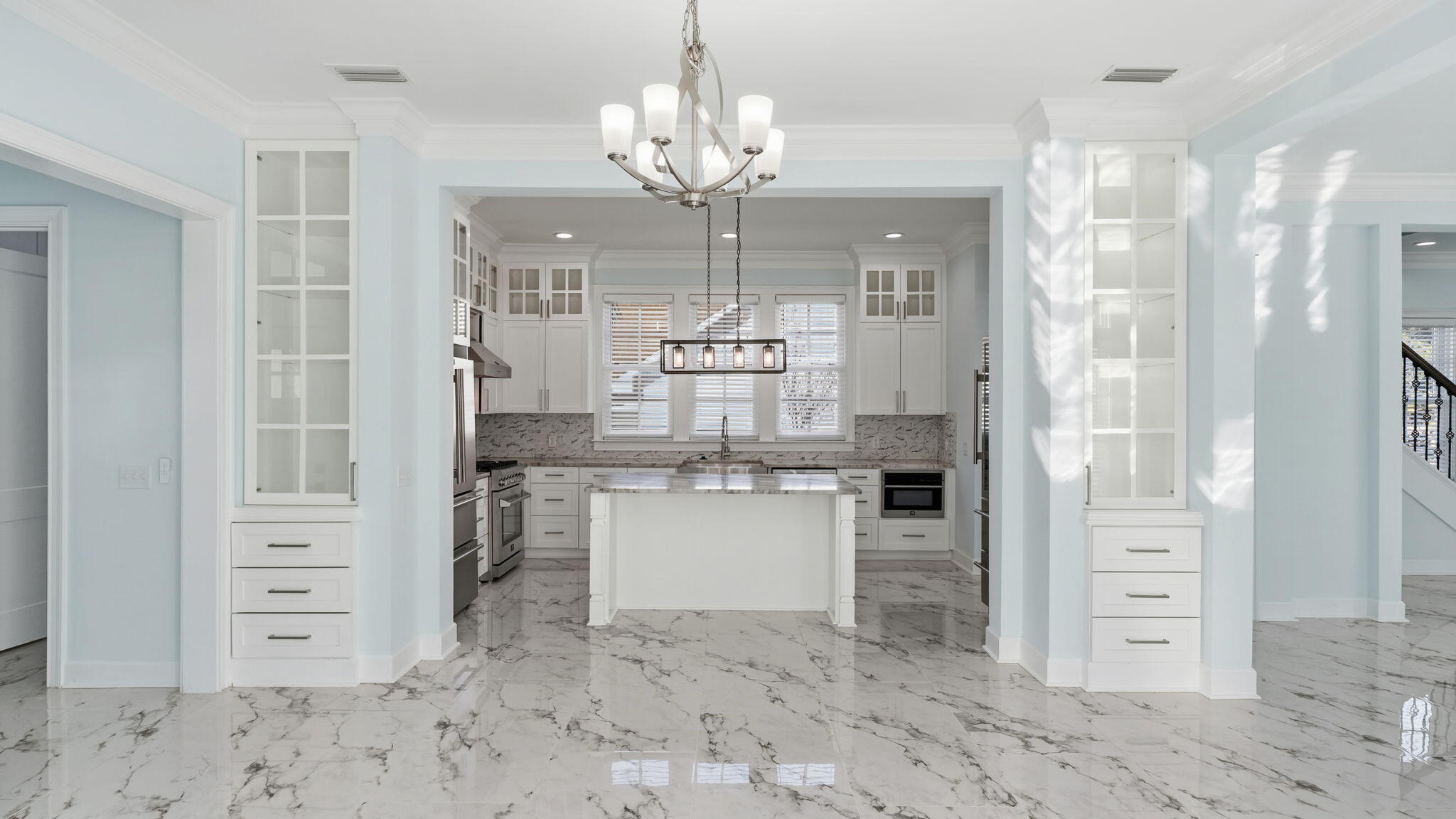165 Staggerbush Street Freeport, FL 32439 - Photo 18 of 68 a room with kitchen island a chandelier and entryway