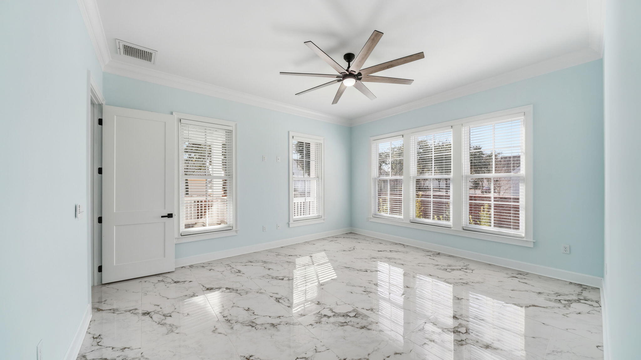 165 Staggerbush Street Freeport, FL 32439 - Photo 24 of 68 a view of a livingroom with a ceiling fan and windows