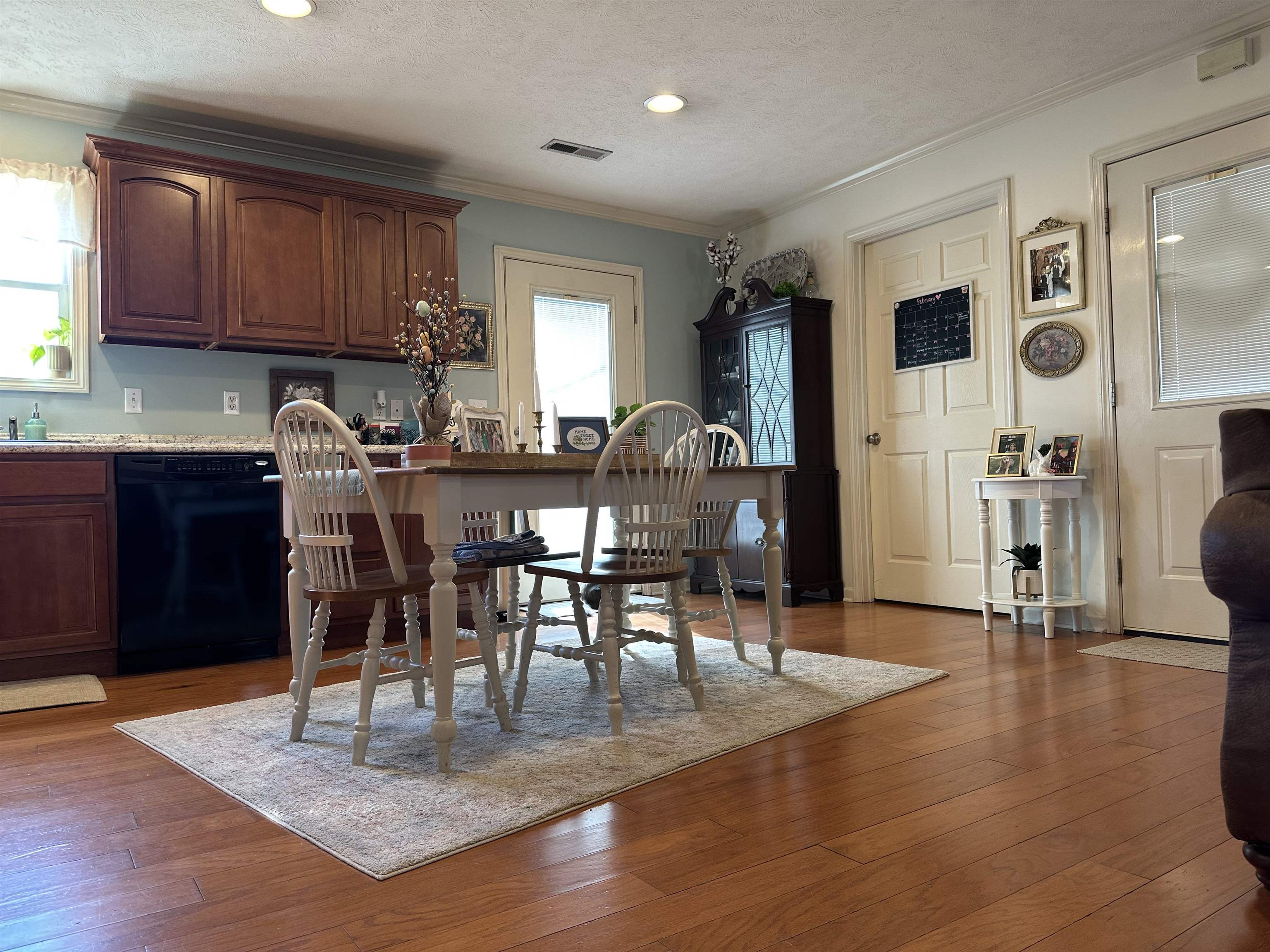 228 Edgewood Drive Adamsville, TN 38310 - Photo 11 of 37 Dining space featuring a textured ceiling, recessed lighting, visible vents, ornamental molding, and wood-type flooring