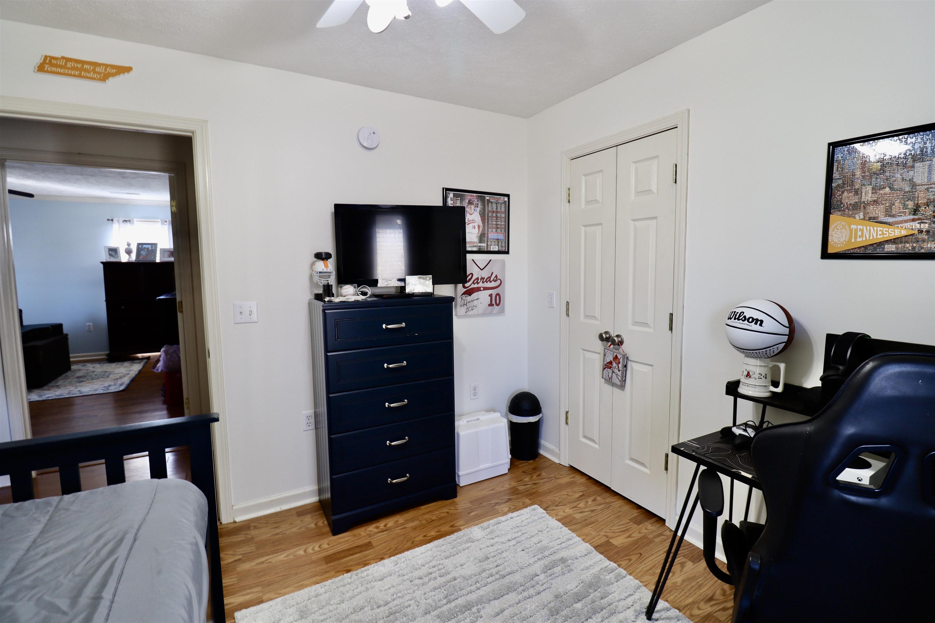 228 Edgewood Drive Adamsville, TN 38310 - Photo 18 of 37 Bedroom featuring light wood finished floors, baseboards, a ceiling fan, and a closet