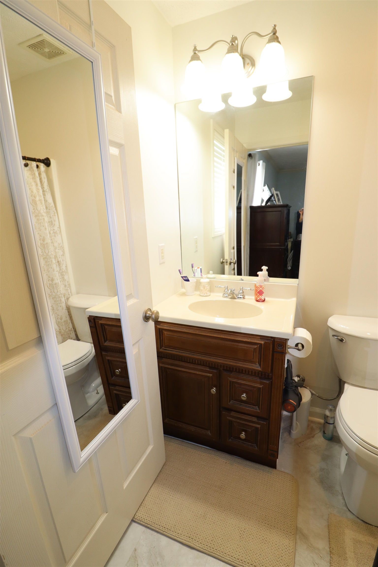 228 Edgewood Drive Adamsville, TN 38310 - Photo 24 of 37 Full bathroom featuring visible vents, vanity, and toilet