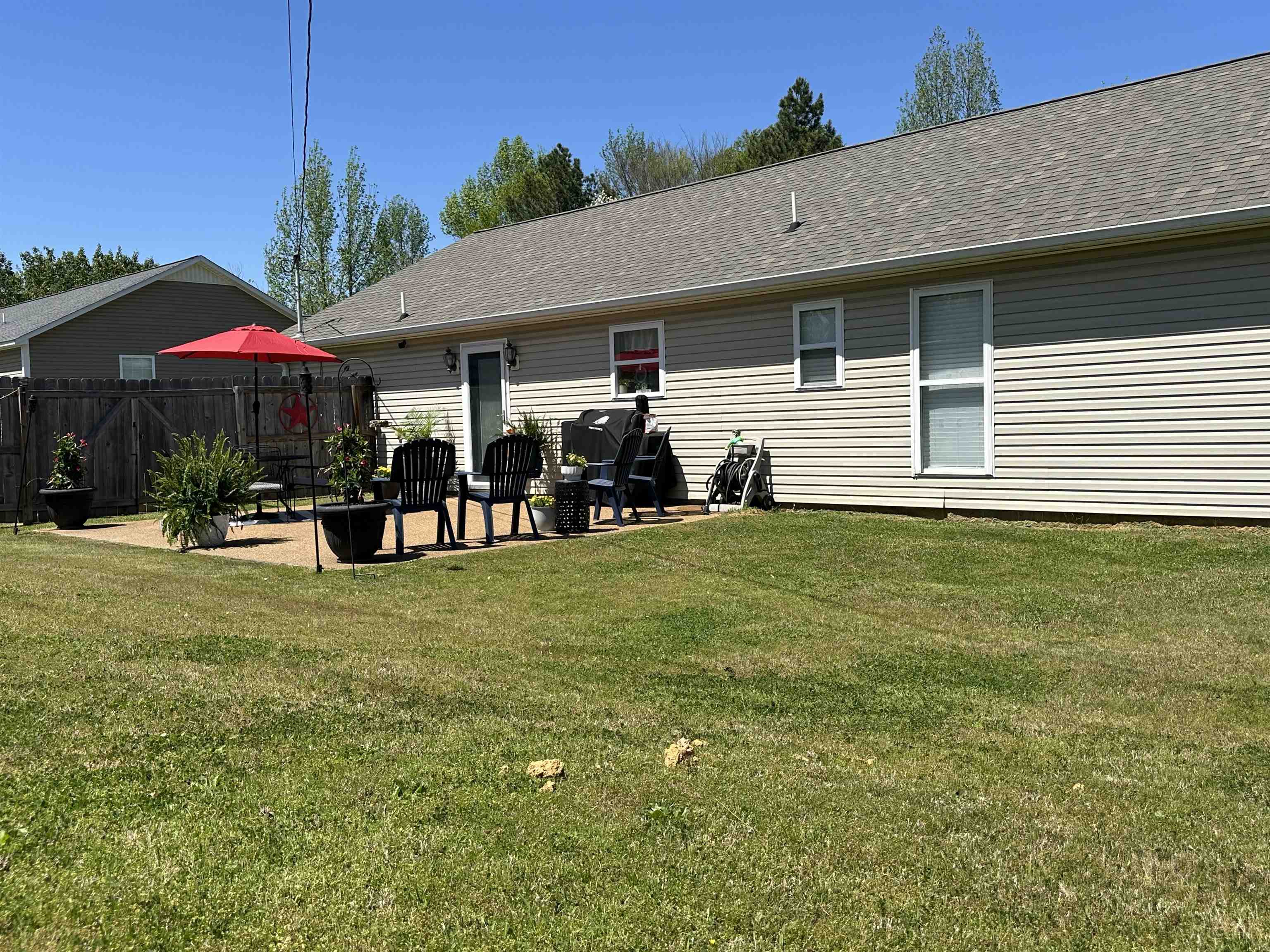 228 Edgewood Drive Adamsville, TN 38310 - Photo 29 of 37 Back of house featuring roof with shingles, a yard, a patio area, and fence