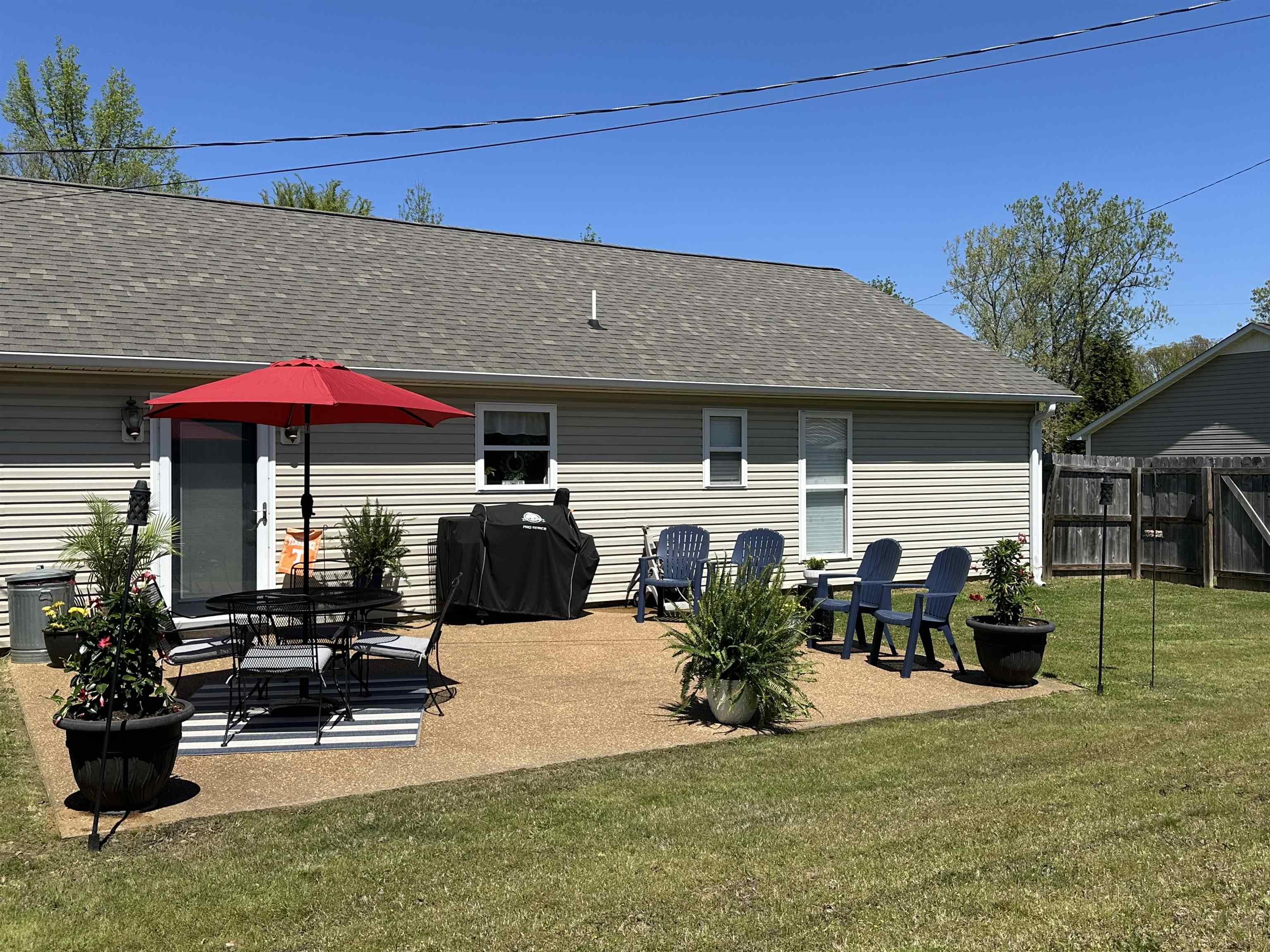 228 Edgewood Drive Adamsville, TN 38310 - Photo 32 of 37 Rear view of house featuring a patio, a shingled roof, fence, and a lawn