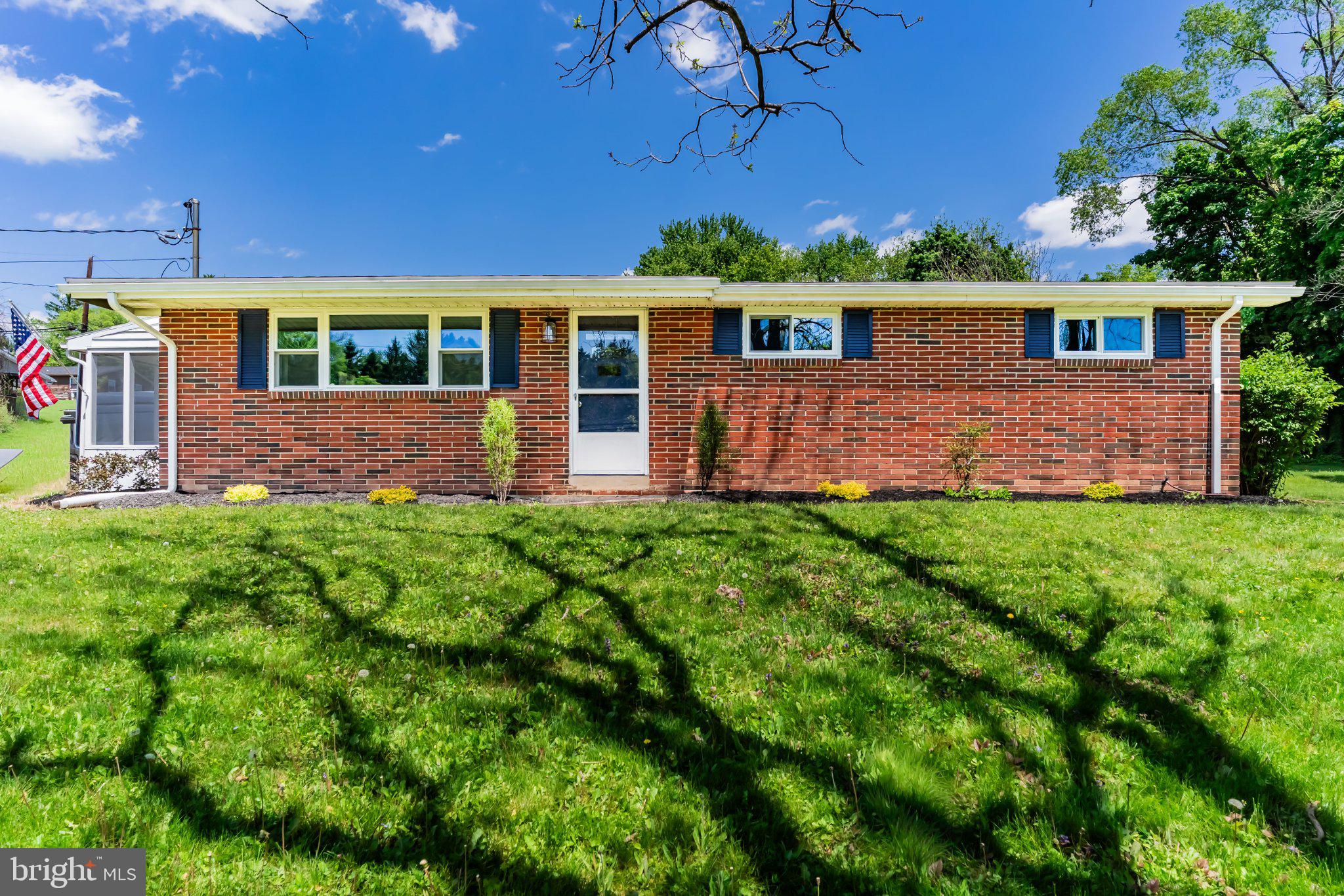 Charming brick home under blue skies.