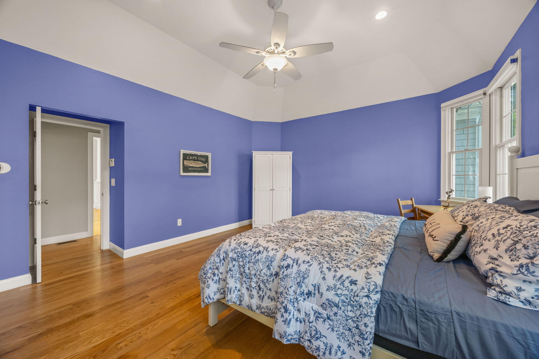 17 Payamps Road Mashpee, MA 02649 - Photo 42 of 72 a bedroom with a bed and a chandelier