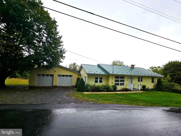 a front view of a house with a garden and plants