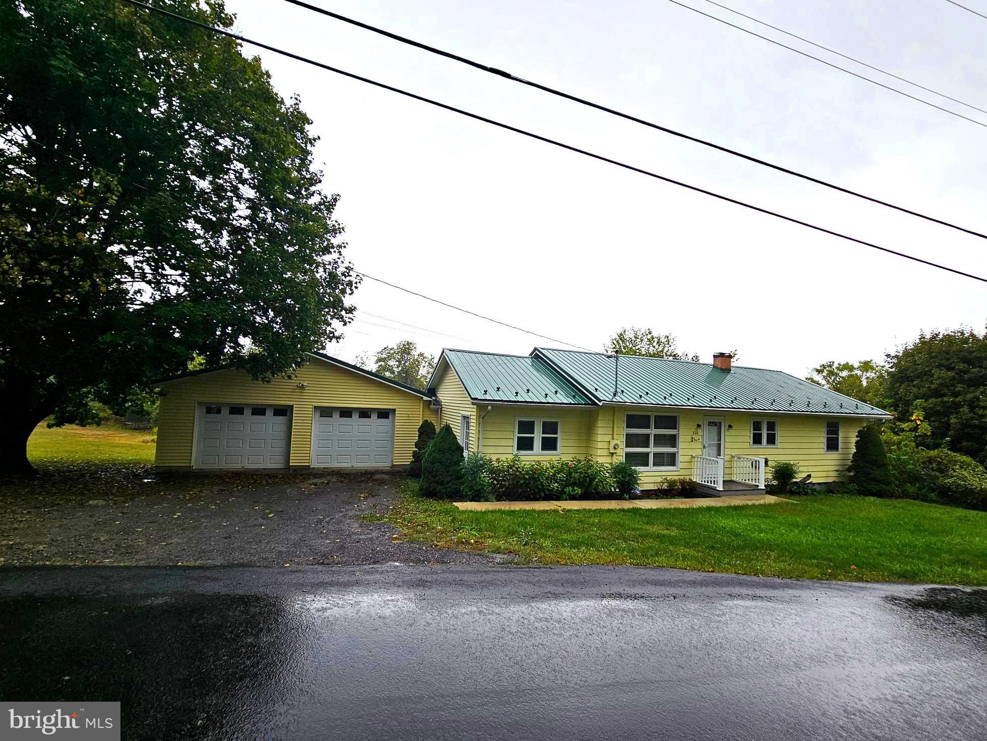 310 Bethel Road Paw Paw, WV 25434 - Photo 1 of 30 a front view of a house with a garden and plants