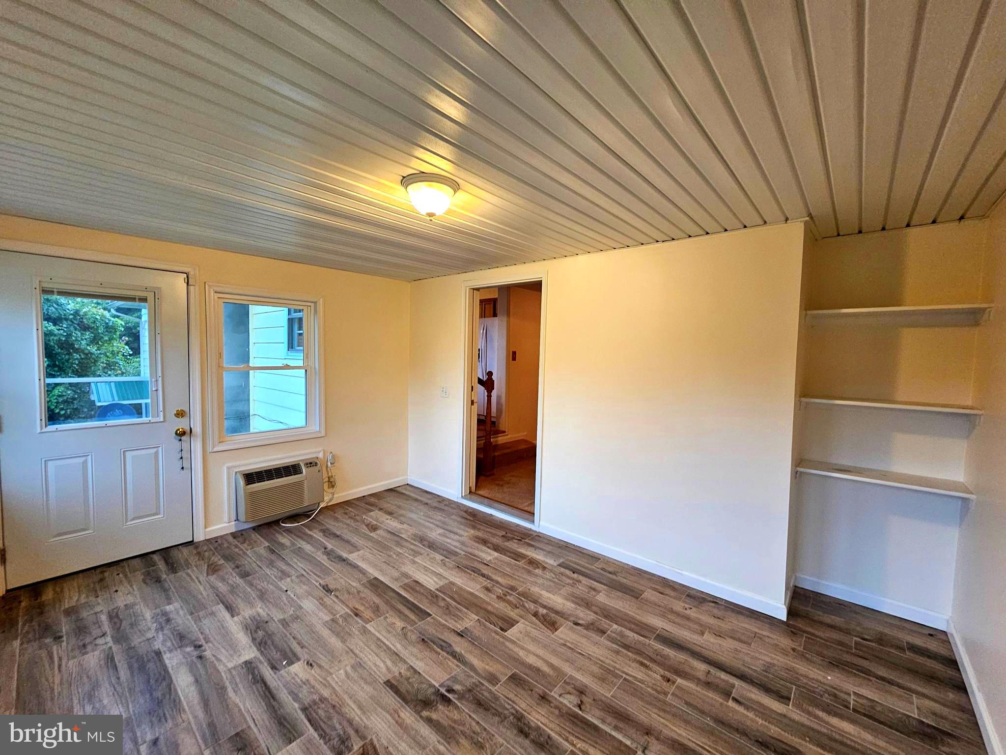 310 Bethel Road Paw Paw, WV 25434 - Photo 12 of 30 a view of an empty room with wooden floor and a window
