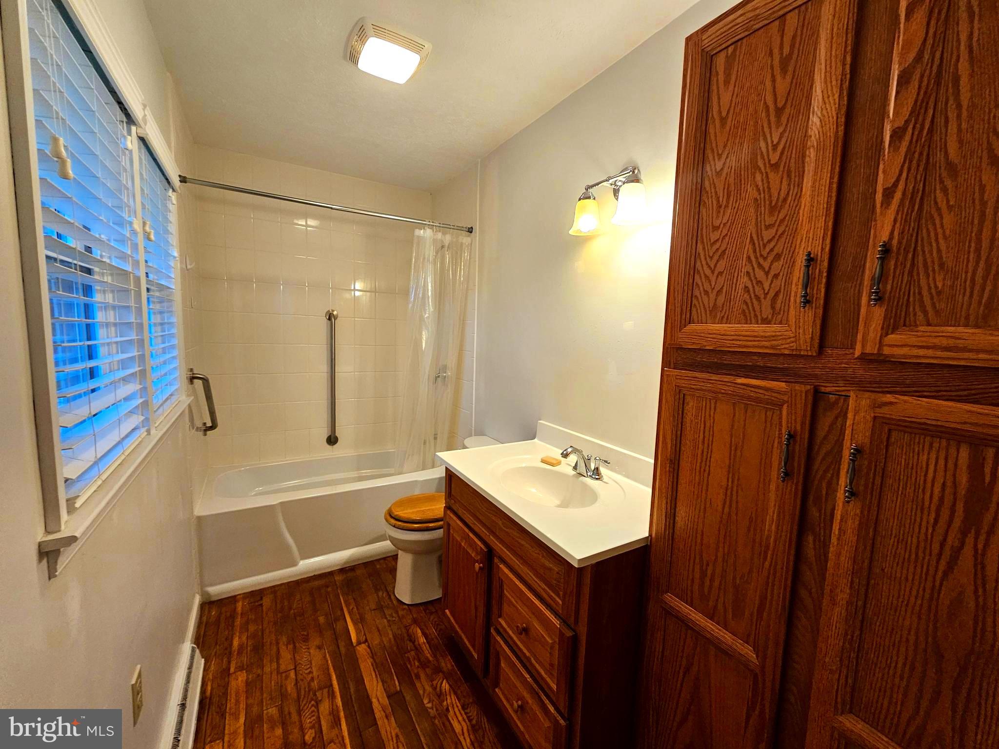 310 Bethel Road Paw Paw, WV 25434 - Photo 16 of 30 a bathroom with a sink a toilet a tub and shower