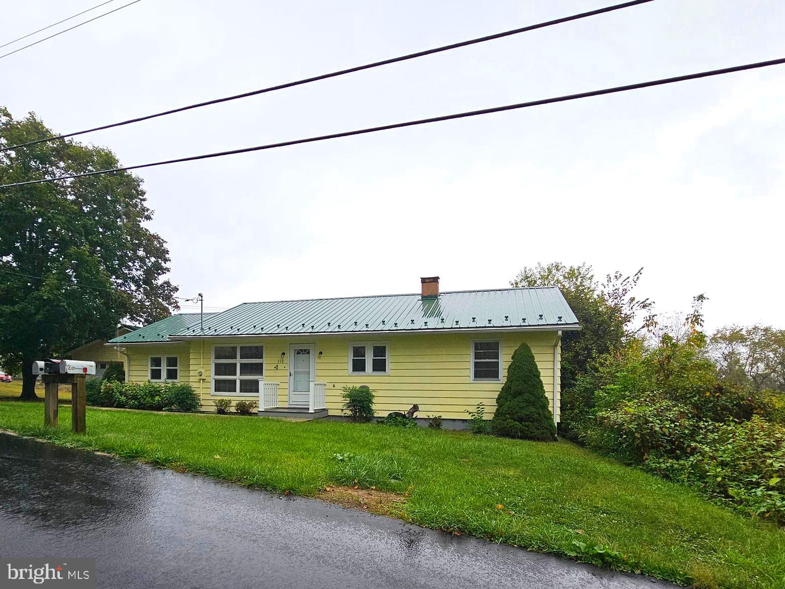 310 Bethel Road Paw Paw, WV 25434 - Photo 30 of 30 a front view of a house with a garden