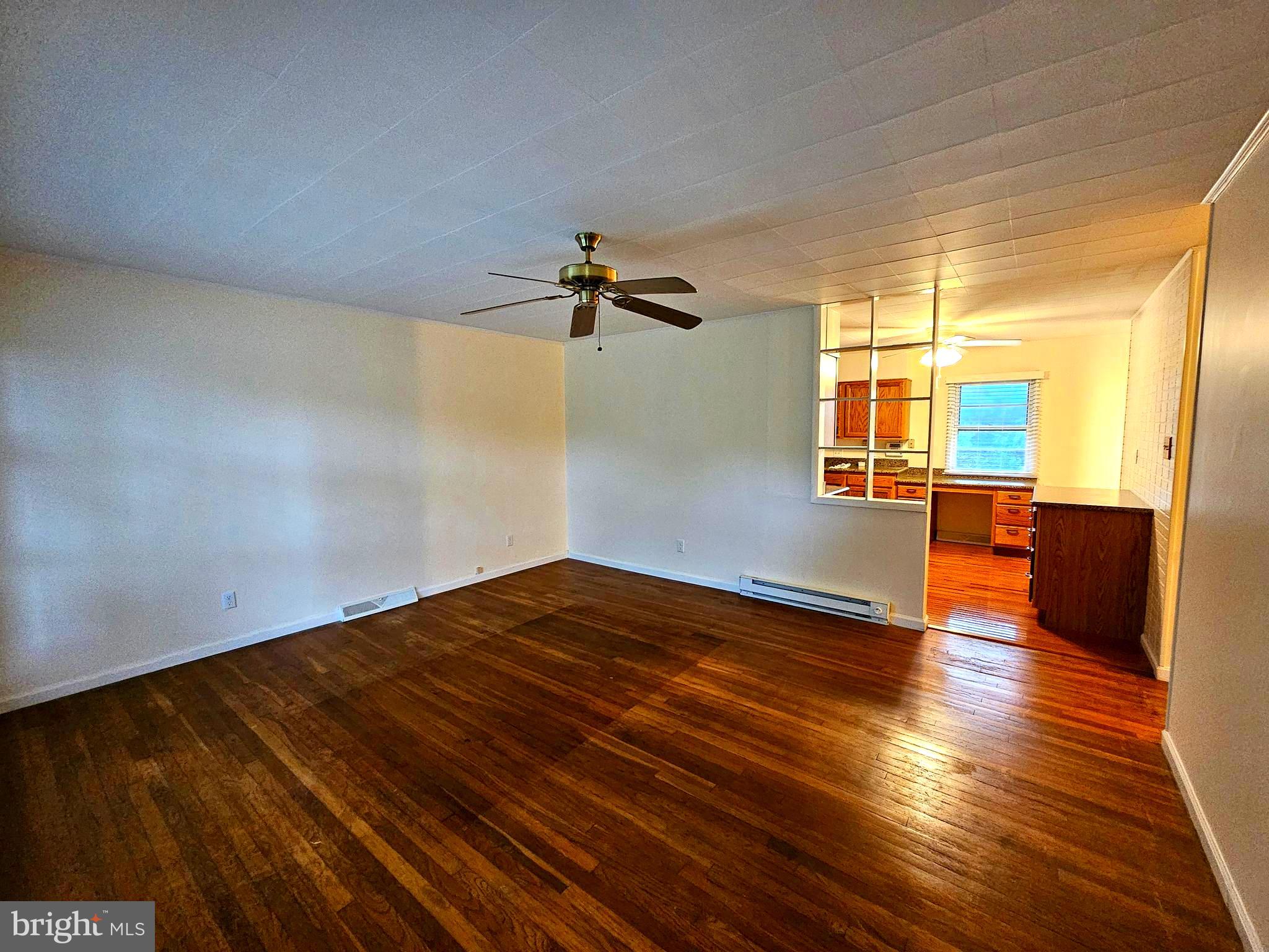 310 Bethel Road Paw Paw, WV 25434 - Photo 6 of 30 wooden floor in an empty room with a window