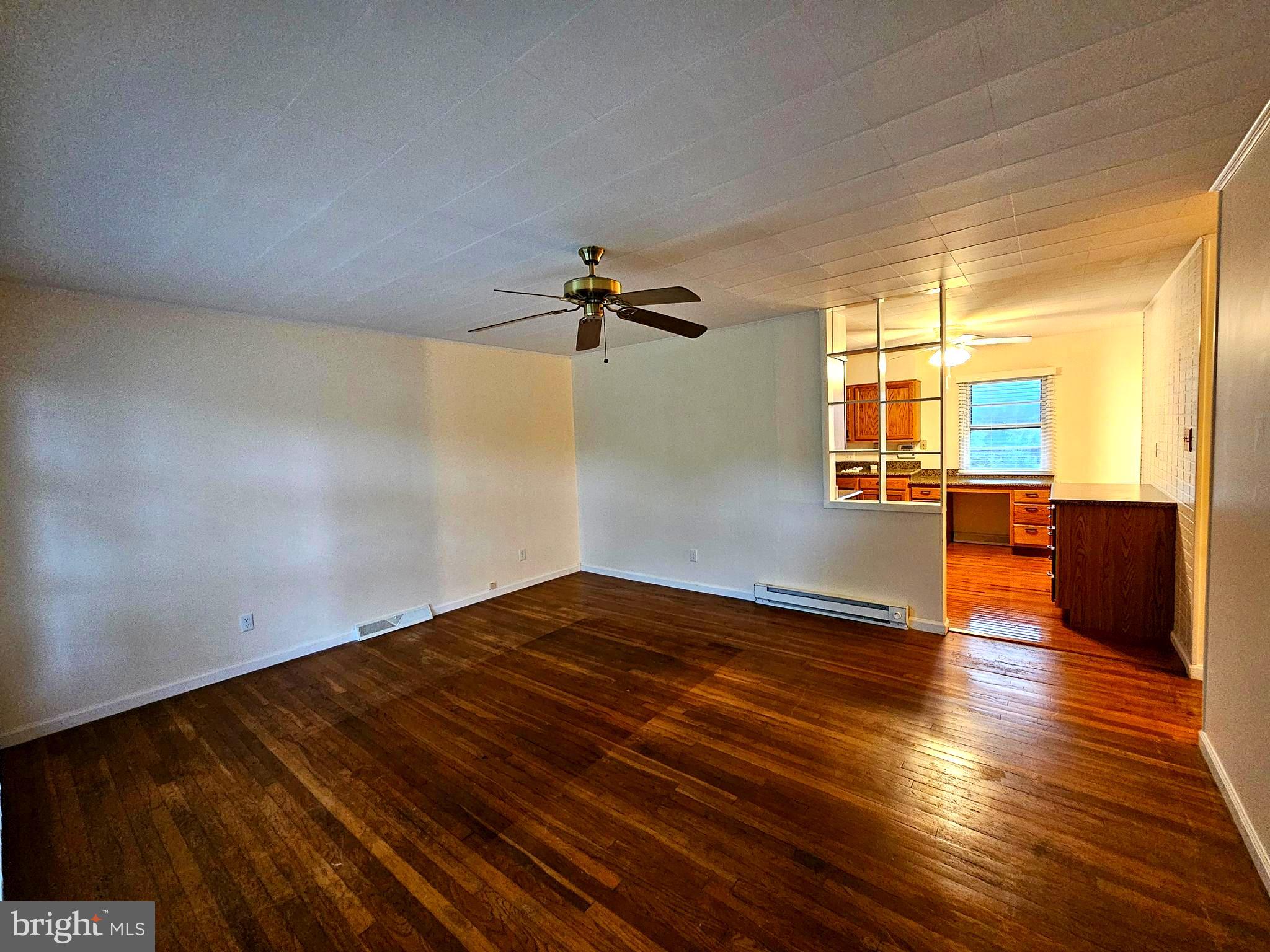 310 Bethel Road Paw Paw, WV 25434 - Photo 8 of 30 wooden floor in an empty room with a window