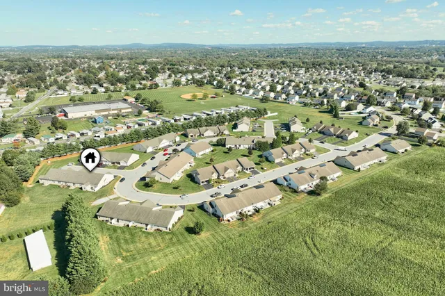an aerial view of residential houses with outdoor space