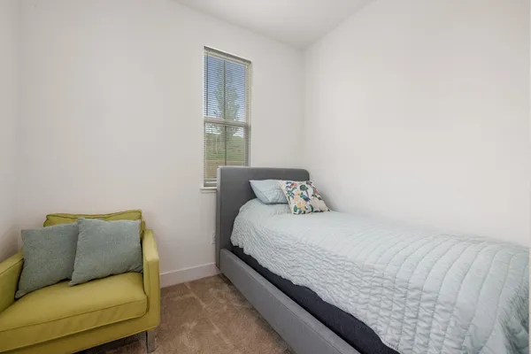 a bedroom with a bed and couch
