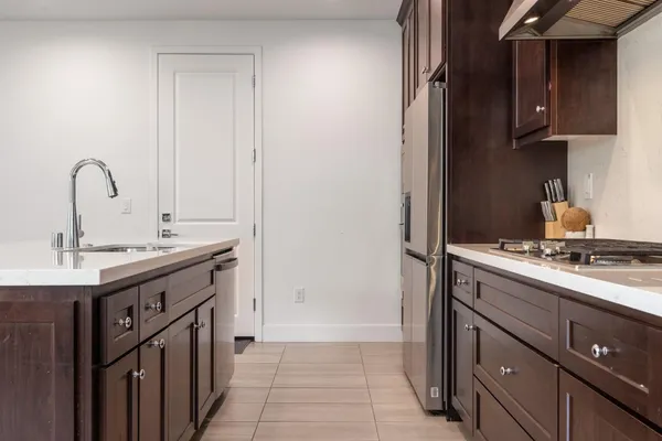 a kitchen with a sink and a stove top oven