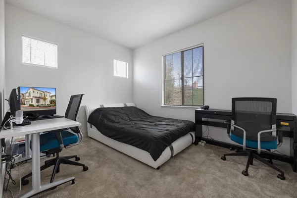 a bedroom with a bed and a desk