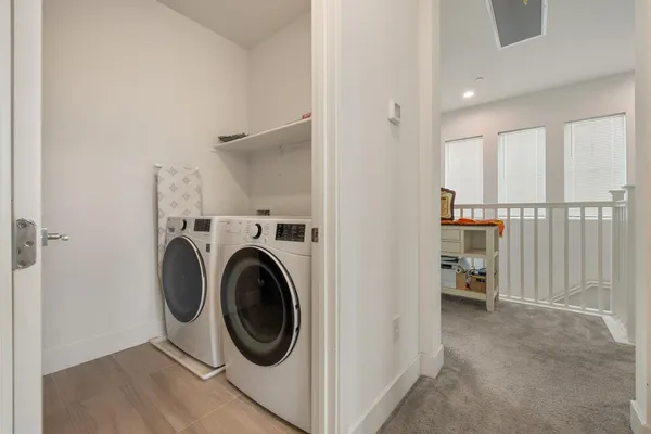a view of a hallway with washer and dryer