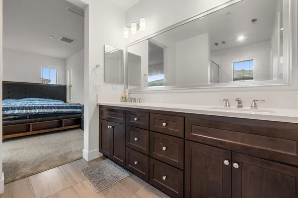 a spacious bathroom with a double vanity sink double and mirror