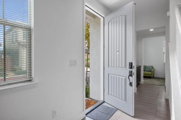 a view of a hallway with closet and a window