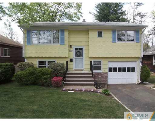 66 East Cliff Road Colonia, NJ 07067 - Photo 1 of 18 a front view of a house with a yard