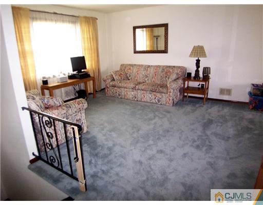 66 East Cliff Road Colonia, NJ 07067 - Photo 2 of 18 a living room with furniture and a flat screen tv