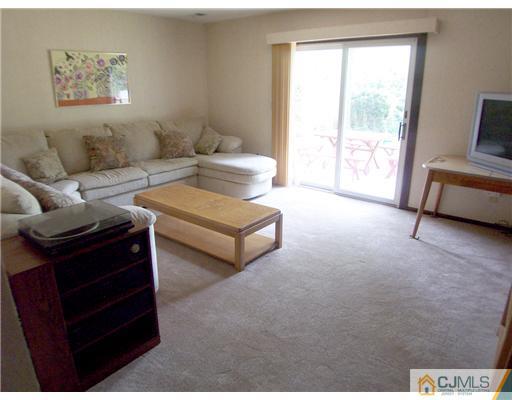 66 East Cliff Road Colonia, NJ 07067 - Photo 12 of 18 a living room with couches and a night stand