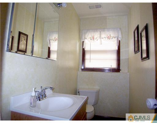 66 East Cliff Road Colonia, NJ 07067 - Photo 14 of 18 a bathroom with a sink and a mirror