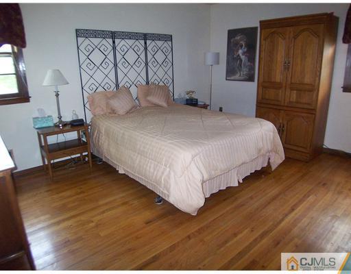 66 East Cliff Road Colonia, NJ 07067 - Photo 9 of 18 a bedroom with a bed and a dresser