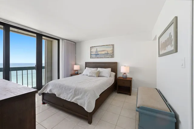 a bedroom with a bed and a large window