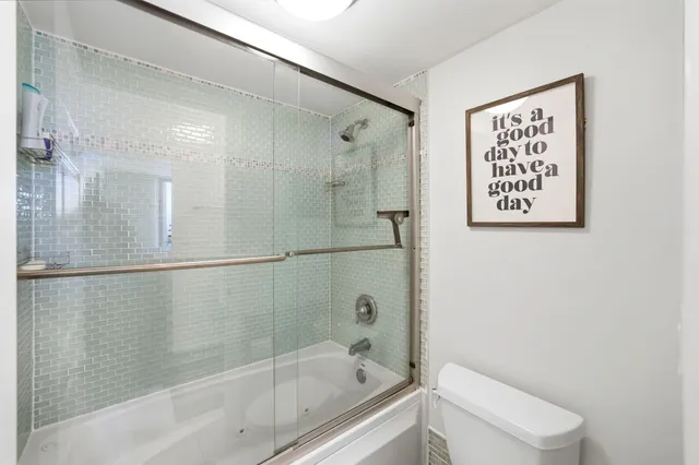 a bathroom with a bathtub and shower