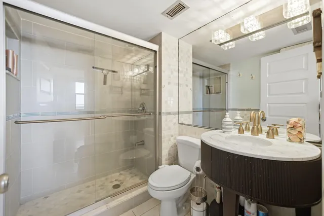 a bathroom with a sink toilet and shower