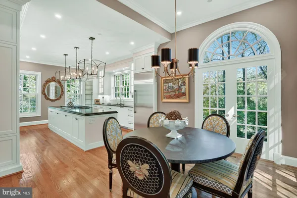 a dining room with furniture a rug and a chandelier