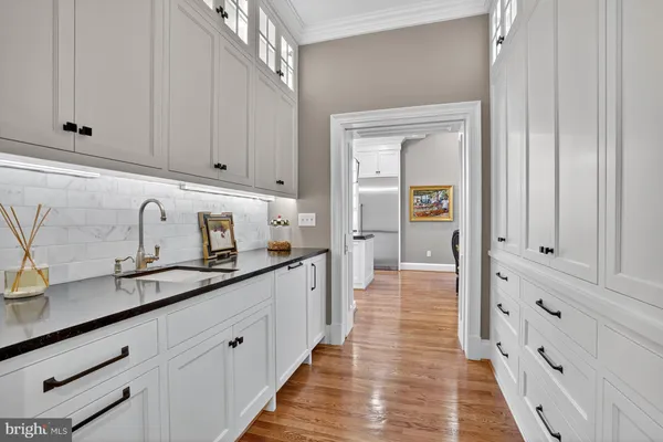 a kitchen with granite countertop white cabinets and sink