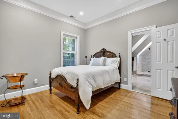 a bedroom with a bed and chair