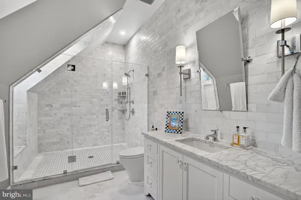 a bathroom with a granite countertop sink mirror and bathtub