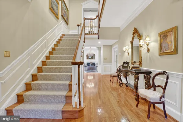 a view of entryway and hall with wooden floor