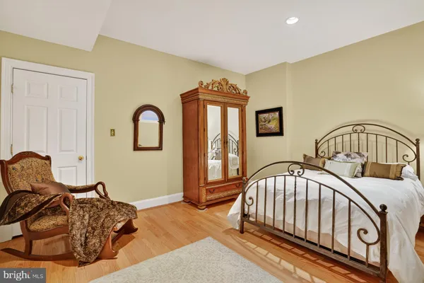 a bedroom with a bed next to a window