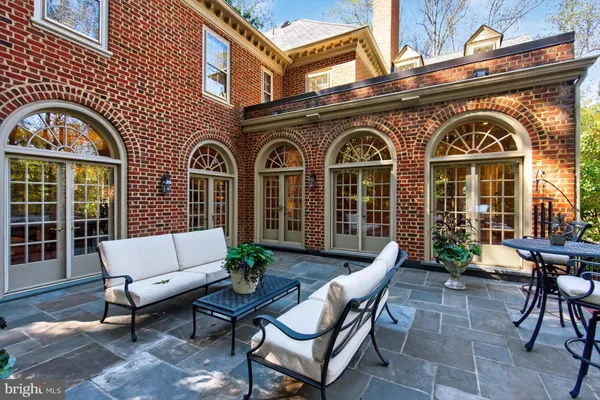 a front view of a house with outdoor seating and a potted plant