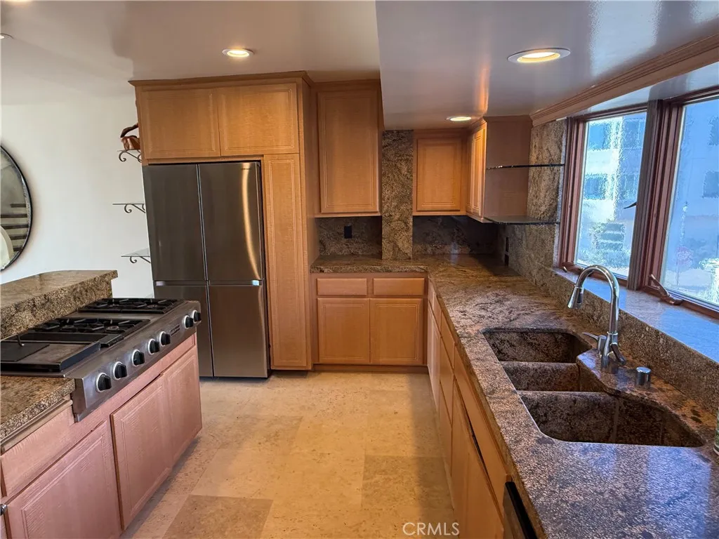 87 Surfside Avenue Surfside, CA 90743 - Photo 14 of 14 a kitchen with stainless steel appliances granite countertop a stove a sink and a refrigerator