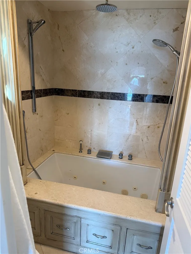 87 Surfside Avenue Surfside, CA 90743 - Photo 10 of 14 a bathroom with a bathtub and shower