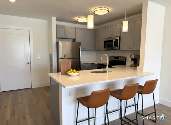 a kitchen with kitchen island a refrigerator stove and microwave