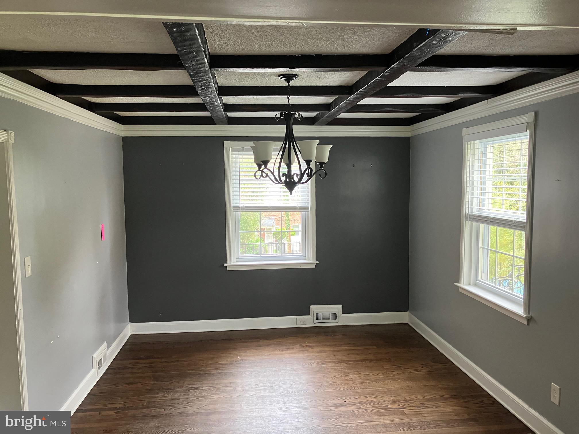 4008 Deepwood Road Baltimore, MD 21218 - Photo 14 of 18 a view of an empty room with wooden floor and a window
